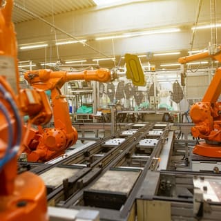 Robotic arms on a factory production line