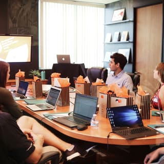 A working session around a table, laptops open